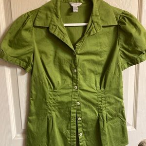 A green satiny short sleeve blouse